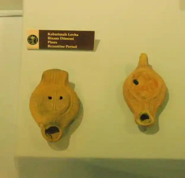 Embossed sheets with solar cross, during the Byzantine period. There are two holes on the cross and also a mouth at the bottom.